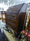 AN INLAID MHOGANY BUREAU WITH THREE LONG DRAWERS