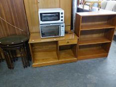 A TEAK THREE-TIER OPEN BOOKCASE, 2?6? WIDE; A NEST OF THREE OVAL COFFEE TABLES WITH GREEN INSET