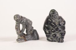 TWENTIETH CENTURY INIUT BLACK SOAPSTONE CARVING, mother feeding child a fish, inscribed to base with