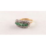 18ct GOLD, EMERALD AND DIAMOND RING set with a row of five round emeralds graduating from the centre