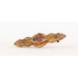 EDWARDIAN 9ct GOLD EMBOSSED WING SHAPED BROOCH set with a tiny ruby, 1 1/2in (3.8cm) wide,