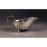 EDWARD VII SILVER SAUCE BOAT, of typical form with flying scroll handle, shaped border and pad feet,