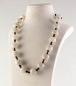 CORD NECKLACE WITH 20 MUTTON FAT JADE BARREL SHAPED BEADS, approximately 20in (50.8cm) long