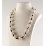 CORD NECKLACE WITH 20 MUTTON FAT JADE BARREL SHAPED BEADS, approximately 20in (50.8cm) long