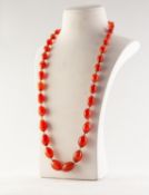 SINGLE STRAND NECKLACE OF GRADUATED OVAL CORNELIAN BEADS, 25in (63.5cm) long