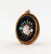 VICTORIAN PIETRA DURA BLACK AND FLORAL OVAL PENDANT in gold coloured metal frame, with top hinged