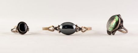 SILVER COLOURED METAL SPRUNG BANGLE, the top collet set with a cabochon oval haematite; SILVER (925)