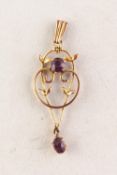 9ct GOLD DELICATE OPENWORK SCROLL PENDANT set with an amethyst and with an oval amethyst drop, 3.