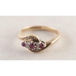 9ct GOLD CROSS-OVER RING set with ten tiny diamonds and three small rubies, 2.9 gms, ring size M/N