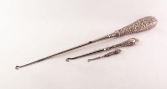 LARGE VICTORIAN BUTTON HOOK, the silver handle repousse with rococo scrolls, 14in (35.5cm) long,