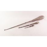 LARGE VICTORIAN BUTTON HOOK, the silver handle repousse with rococo scrolls, 14in (35.5cm) long,