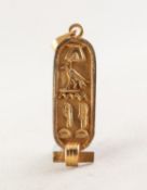 EGYPTIAN GOLD COLOURED METAL ROUNDED OBLONG PENDANT, cave relievo with hieroglypyhs, 1 1/4in (3.1cm)