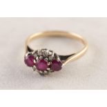 9ct GOLD RING set with a row of three rubies and eight tiny diamonds, 2.1 gms, ring size M