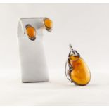 W. KRUK CRAFT SILVER AND BUTTERSCOTCH AMBER LARGE TEAR SHAPED PENDANT and a PAIR OF OVAL