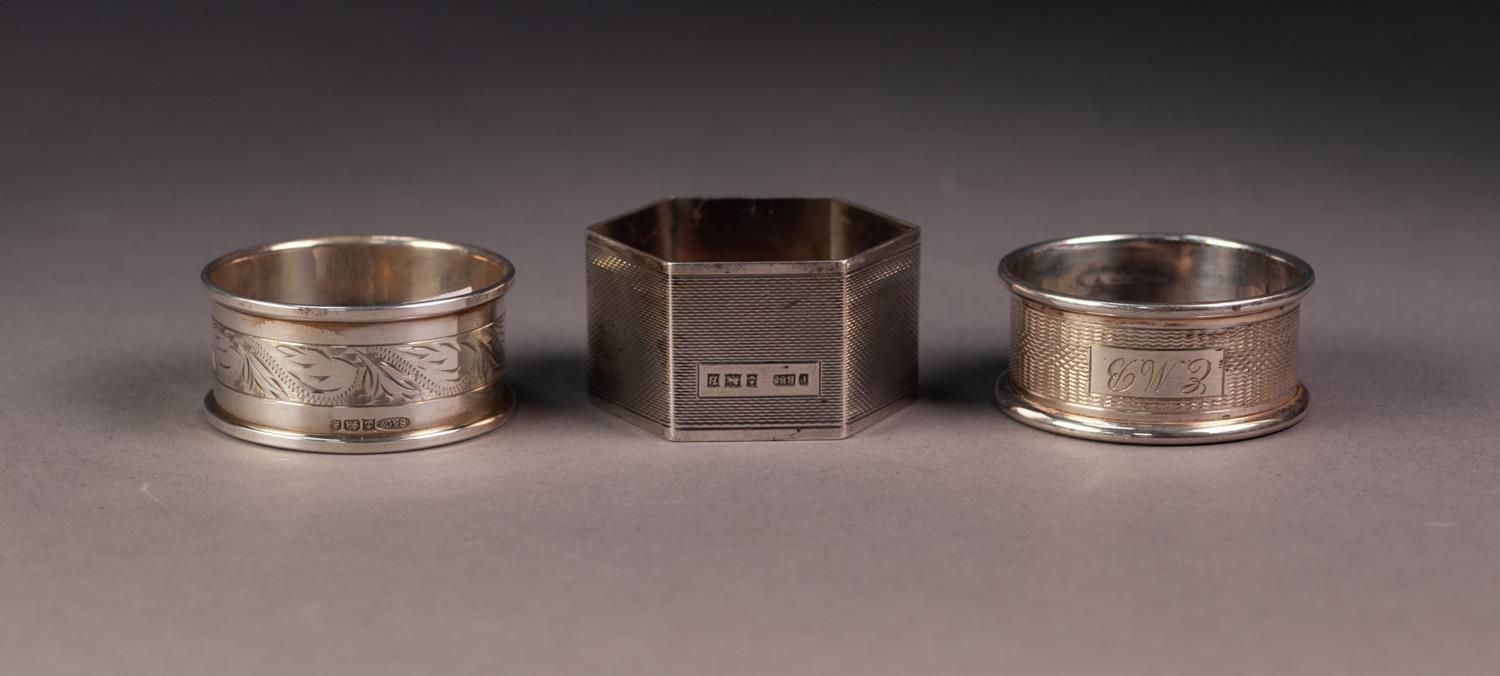 THREE SILVER NAPKIN RINGS, including a HEXAGONAL ENGINE TURNED example, Birmingham 1951, all