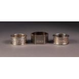 THREE SILVER NAPKIN RINGS, including a HEXAGONAL ENGINE TURNED example, Birmingham 1951, all