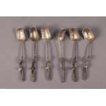 FANCY SET OF SIX UNMARKED SILVER COLOURED METAL COFFEE SPOONS, each with embossed leaf shaped bowl