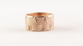 9ct GOLD BROAD WEDDING RING, the engine turned ground bright cut engraved with leaf motifs, London