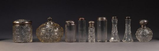 FOUR CUT GLASS TOILET JARS WITH EMBOSSED SILVER COVERS, together with a PAIR OF CUT GLASS BUD