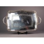 GEORGE V SILVER TWO HANDLED TRAY, of oblong form with gadrooned border to the serpentine outline,