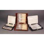 CASED SET OF SIX AFTERNOON TEA KNIVES WITH FILLED SILVER HANDLES, together with TWO CASED SETS OF