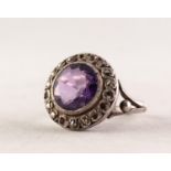 SILVER COLOURED METAL AND MARCASITE RING set with a brilliant cut amethyst, with broad marcasite set