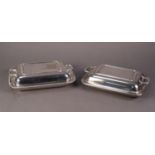 TWO ELECTROPLATE OBLONG ENTREE DISHES AND TWO HANDLED COVERS, one with oven proof glass liner (2)