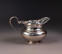 GEORGE V SILVER MILK JUG, of bellied, footed form with floral cast and pierced border, conforming