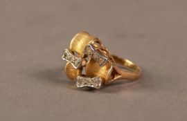 GOLD AND PLATINUM ORGANIC FORM DESIGNER RING, the cast triform top also with nine white stones in