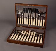 EARLY 20th CENTURY WOODEN CASED SET OF TWELVE PLATED FISH KNIVES AND FORKS, with silver ferrules,