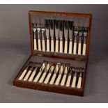EARLY 20th CENTURY WOODEN CASED SET OF TWELVE PLATED FISH KNIVES AND FORKS, with silver ferrules,
