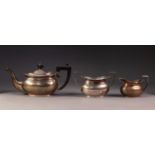 GEORGE V THREE PIECE SILVER TEA SET, of oval bellied form with angular black scroll handle and knop,