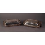 TWO ELECTROPLATED TWO HANDLED OBLONG ENTRÉE DISHES WITH COVERS, one plain, the other with Celtic