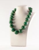 SINGLE STRAND NECKLACE OF TWENTY ONE LARGE, ROUND GREEN JADE BEADS, 17in (43.1cm) long