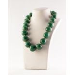 SINGLE STRAND NECKLACE OF TWENTY ONE LARGE, ROUND GREEN JADE BEADS, 17in (43.1cm) long