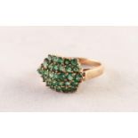 9ct GOLD AND EMERALD DOMED OVAL CLUSTER RING, having five rows of tiny emeralds, twenty nine in all,