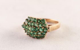 9ct GOLD AND EMERALD DOMED OVAL CLUSTER RING, having five rows of tiny emeralds, twenty nine in all,