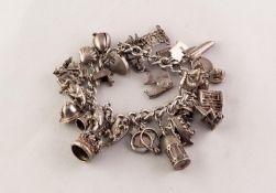 SILVER CURB LINK CHARM BRACELET with padlock clasp and approximately 30 silver charms, 3.95 oz