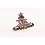 GOLD AND ENAMELLED ROYAL ARTILLERY BADGE, the wheel of the cannon set with thirteen tiny diamonds,