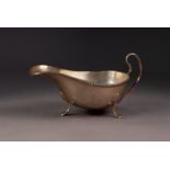 GEORGE V SILVER SAUCE BOAT, of typical form with high scroll handle, slender gadrooned border and
