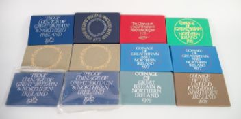 TWELVE ?PROOF COINAGE OF GREAT BRITAIN & NORTHERN IRELAND? SETS IN COLOURED CARD ENVELOPE TYPE