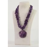THREE STRAND CHIP AMETHYST BEAD NECKLACE with large purple stained carved mother of pearl and chip