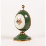 TWENTIETH CENTURY LIMOGES CHINA AND GILT METAL EGG SHAPED SCENT BOTTLE HOLDER, green with floral