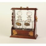 POST WAR MAHOGANY AND BRASS MOUNTED TWO BOTTLE TANTALUS, with locking hinged fall front panel,