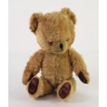 MID TWENTIETH CENTURY BLOND PLUSH TEDDY BEAR, wool filled with bells sewn into the ears and with