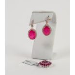 PAIR OF STERLING EARRINGS each set with a large oval red stone and surround of tiny white stones and