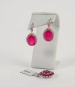 PAIR OF STERLING EARRINGS each set with a large oval red stone and surround of tiny white stones and