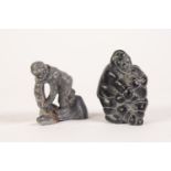 TWENTIETH CENTURY INIUT BLACK SOAPSTONE CARVING, mother feeding child a fish, inscribed to base with