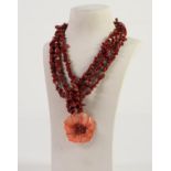 THREE STRAND DARK RED CHIP CORAL BEAD NECKLACE with large red stained carved mother of pearl and