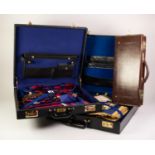 A BLACK LEATHER AND BLACK FABRIC CASE CONTAINING MASONIC REGALIA FOR WEST LANCASHIRE AND EAST